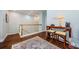 An upstairs landing with wood flooring, desk, seating and stylish decor at 2674 Tanglewood Trl, Palm Harbor, FL 34685