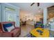 Open living room featuring neutral decor, ceramic tile and views to the kitchen and staircase at 2674 Tanglewood Trl, Palm Harbor, FL 34685