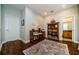 Cozy home office with wood floors, area rug, ample light, desk and bookshelf at 2674 Tanglewood Trl, Palm Harbor, FL 34685