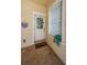 Welcoming front porch with ceramic tile and custom storm door at 2674 Tanglewood Trl, Palm Harbor, FL 34685