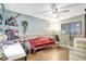 Charming bedroom with a unique decor, wood floors, a fan, and a window at 2811 S Pines Dr # 15, Largo, FL 33771