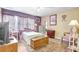 Bright bedroom with charming decor, wood floors, and a large window at 2811 S Pines Dr # 15, Largo, FL 33771