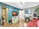 Eclectic bedroom featuring an accent wall, TV, open shelving, a sofa and a desk at 2811 S Pines Dr # 15, Largo, FL 33771