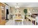A classic dining room featuring a chandelier, display cabinet, and neutral decor create a cozy atmosphere at 2811 S Pines Dr # 15, Largo, FL 33771