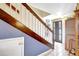 The home's entryway features stairs with wooden banisters and a glimpse of the neutral interiors at 2811 S Pines Dr # 15, Largo, FL 33771