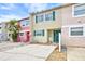 Inviting two-story townhouse with vibrant facade, shutters, and well-maintained landscaping at 2811 S Pines Dr # 15, Largo, FL 33771