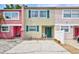 Charming townhouse featuring colorful exteriors, green shutters, and a welcoming front porch at 2811 S Pines Dr # 15, Largo, FL 33771