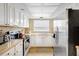 A functional kitchen with white cabinetry, a stainless steel fridge, and tile floors for easy cleaning at 2811 S Pines Dr # 15, Largo, FL 33771