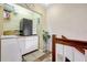 Functional laundry room with storage cabinets, counter space, and staircase access at 2811 S Pines Dr # 15, Largo, FL 33771