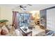A comfortable living room with a decorative fireplace features sliding doors that open to a screened patio at 2811 S Pines Dr # 15, Largo, FL 33771
