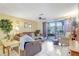 The living room is brightened by tile floors and features sliding glass doors opening to the patio at 2811 S Pines Dr # 15, Largo, FL 33771