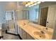 Bright bathroom features dual sinks, walk-in shower, and soaking tub at 28818 Midnight Star Loop, Wesley Chapel, FL 33543