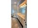 Bathroom showcasing double sink vanity, tiled floors, and walk-in shower at 28818 Midnight Star Loop, Wesley Chapel, FL 33543