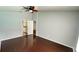 Bedroom featuring hardwood floors, ceiling fan, and bathroom view at 28818 Midnight Star Loop, Wesley Chapel, FL 33543