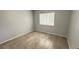 Bright bedroom with tile floors and a window providing natural light at 28818 Midnight Star Loop, Wesley Chapel, FL 33543