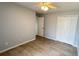 Neutral bedroom features tile flooring, ample closet space, and a ceiling fan at 28818 Midnight Star Loop, Wesley Chapel, FL 33543