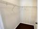 Walk in closet with a dark wood-look floor and wire shelving at 28818 Midnight Star Loop, Wesley Chapel, FL 33543