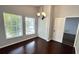 Dining room featuring hardwood floors, a chandelier, and natural light from windows at 28818 Midnight Star Loop, Wesley Chapel, FL 33543