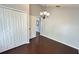 Dining area featuring hardwood floors, a chandelier, closet space, and an open doorway at 28818 Midnight Star Loop, Wesley Chapel, FL 33543