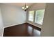 Bright dining room with hardwood floors, a chandelier, and two large windows at 28818 Midnight Star Loop, Wesley Chapel, FL 33543
