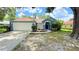 Charming single-story home with a well-maintained lawn and a two-car garage at 28818 Midnight Star Loop, Wesley Chapel, FL 33543