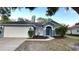 Charming single-Gathering home with a well-maintained lawn and attached two-car garage at 28818 Midnight Star Loop, Wesley Chapel, FL 33543