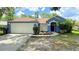 Charming single-story home with a well-maintained lawn and a two-car garage at 28818 Midnight Star Loop, Wesley Chapel, FL 33543