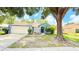 Inviting single-story home featuring a well-manicured lawn and a two-car garage at 28818 Midnight Star Loop, Wesley Chapel, FL 33543