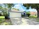 A traditional-style home with a two-car garage, neatly trimmed lawn, and a welcoming entrance at 28818 Midnight Star Loop, Wesley Chapel, FL 33543