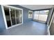 Enclosed lanai with speckled floors and view of backyard and neighborhood at 28818 Midnight Star Loop, Wesley Chapel, FL 33543