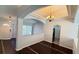 Spacious living room featuring tile floors, neutral paint, and elegant archways with ceiling decor at 28818 Midnight Star Loop, Wesley Chapel, FL 33543