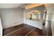 Open-concept living room with hardwood floors and archway to the kitchen and other living areas at 28818 Midnight Star Loop, Wesley Chapel, FL 33543