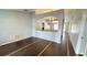 Open-concept living room featuring wood-look tile floors and archways to dining and other rooms at 28818 Midnight Star Loop, Wesley Chapel, FL 33543