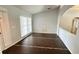 Bright living space featuring arched doorway, modern flooring, and large window at 28818 Midnight Star Loop, Wesley Chapel, FL 33543