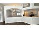 Bright and airy living area featuring archways, modern flooring, and a glimpse of the kitchen at 28818 Midnight Star Loop, Wesley Chapel, FL 33543