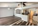 Open-concept living space connecting to a kitchen, with wood-look tile flooring at 28818 Midnight Star Loop, Wesley Chapel, FL 33543