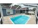 Backyard with a screened-in pool, creating a peaceful outdoor retreat at 28818 Midnight Star Loop, Wesley Chapel, FL 33543