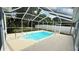 The private screened-in pool with a concrete deck provides a serene outdoor oasis for relaxation and enjoyment at 28818 Midnight Star Loop, Wesley Chapel, FL 33543