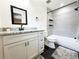 Modern bathroom featuring sleek gray tile, black fixtures, and a stylish vanity with granite countertop at 3114 Little Rd, Valrico, FL 33596