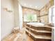 Bright bathroom featuring a garden tub with mosaic accents and tile flooring at 3114 Little Rd, Valrico, FL 33596