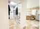 Bathroom featuring walk-in closet, garden tub with mosaic accents, and white vanity at 3114 Little Rd, Valrico, FL 33596