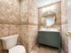 Stylish powder room with unique tile, gold accents, and a modern vanity, perfect for guests at 3114 Little Rd, Valrico, FL 33596
