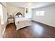 Comfortable bedroom features plush bed, hardwood floor and natural light at 3114 Little Rd, Valrico, FL 33596