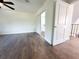 Clean bedroom with wood flooring and a double sliding door closet, great for any storage needs at 3114 Little Rd, Valrico, FL 33596