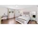 Bright bedroom featuring a large bed, wood floors, and neutral decor, creating a serene and inviting space at 3114 Little Rd, Valrico, FL 33596