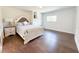 Comfortable bedroom features plush bed, hardwood floor and natural light at 3114 Little Rd, Valrico, FL 33596