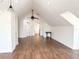 Spacious bonus room features modern ceiling fan, wood floors and neutral paint at 3114 Little Rd, Valrico, FL 33596