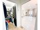 Walk-in closet featuring view to bedroom with crystal chandelier and marble details at 3114 Little Rd, Valrico, FL 33596