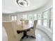 Dining room boasts natural light, marble floors, and seating for four at 3114 Little Rd, Valrico, FL 33596