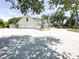 The driveway is spacious and is adorned with mature trees at 3114 Little Rd, Valrico, FL 33596